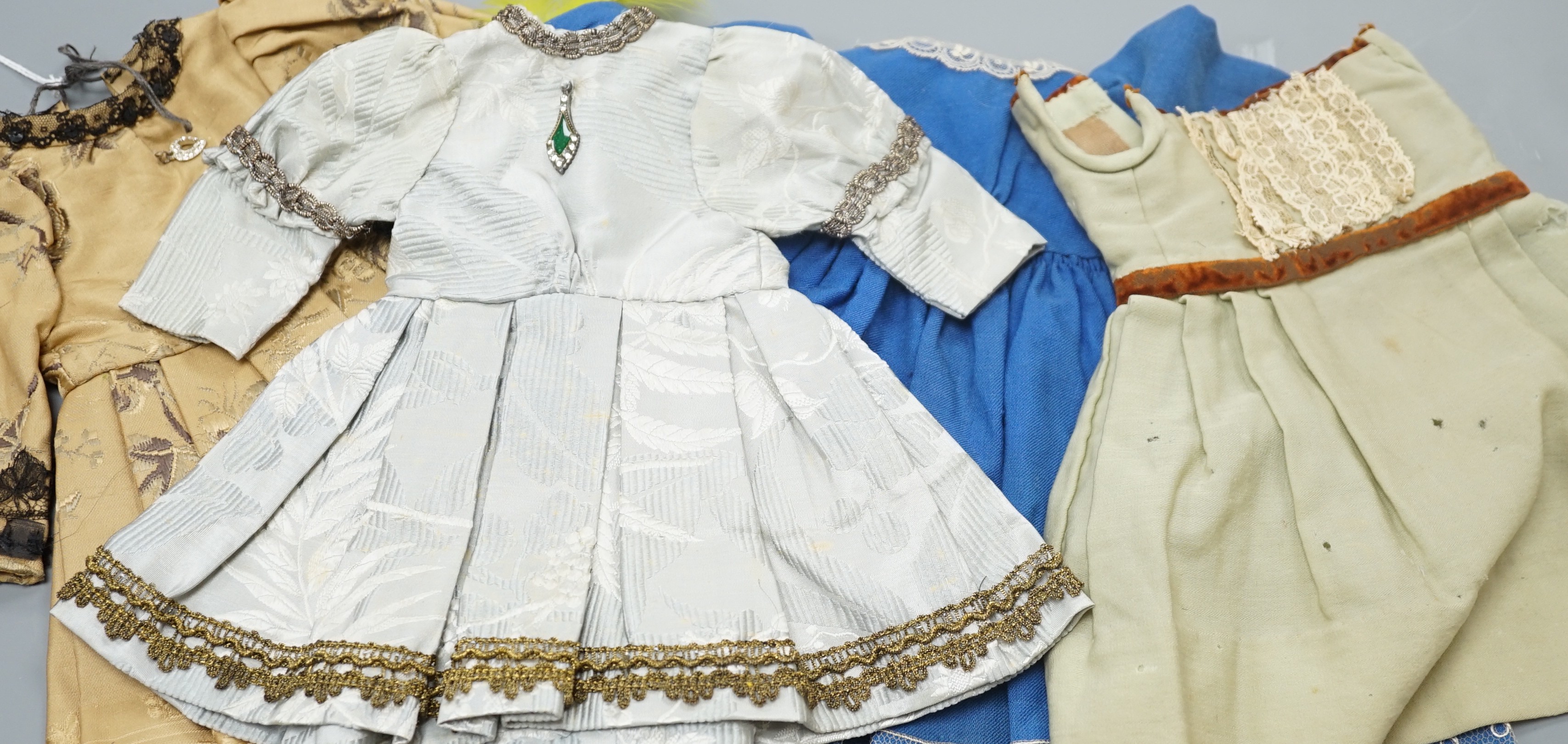 Eight dolls dresses and one hat, average 26cm